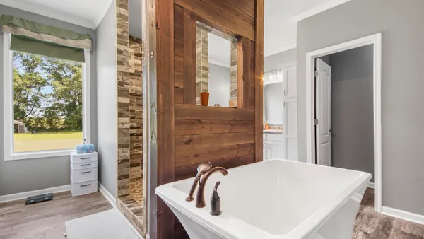 a bathroom with a bathtub and window