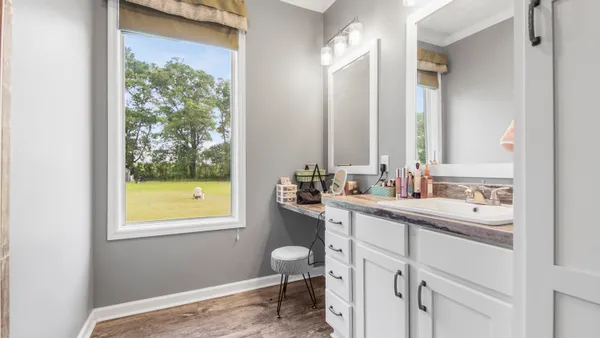 a bathroom with a sink a toilet and a window