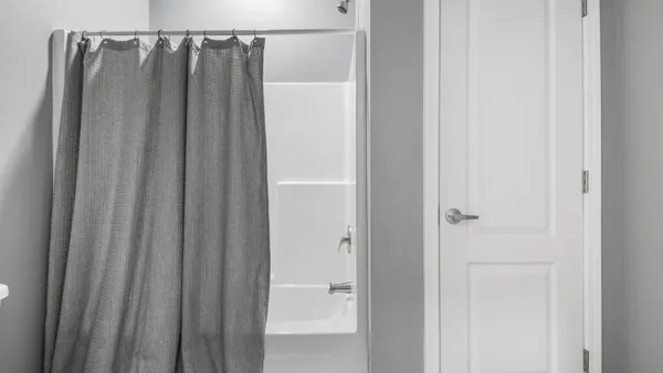 a bathroom with a shower and a mirror