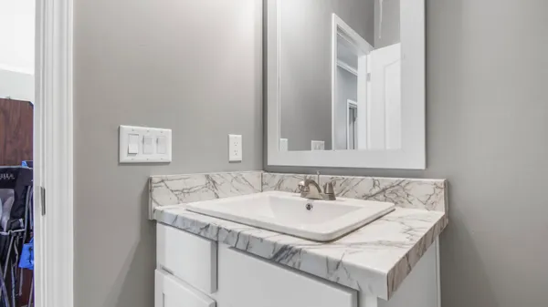 a bathroom with a sink and a mirror