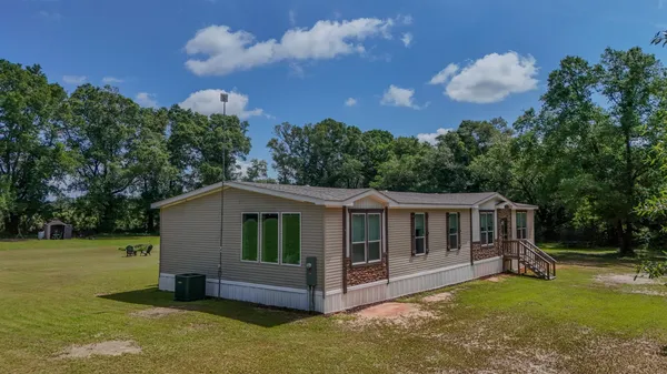 a view of house with yard and entertaining space