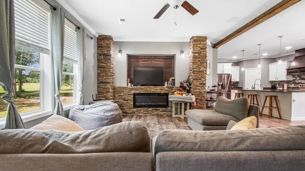 a living room with furniture and a flat screen tv