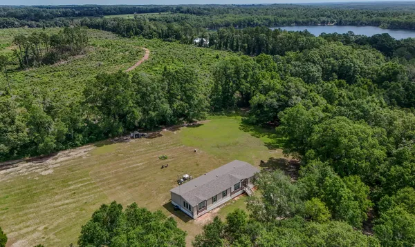 an aerial view of a house with a yard