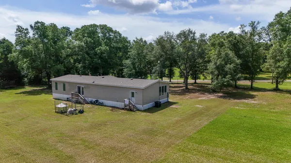 a small garden with trees in the background