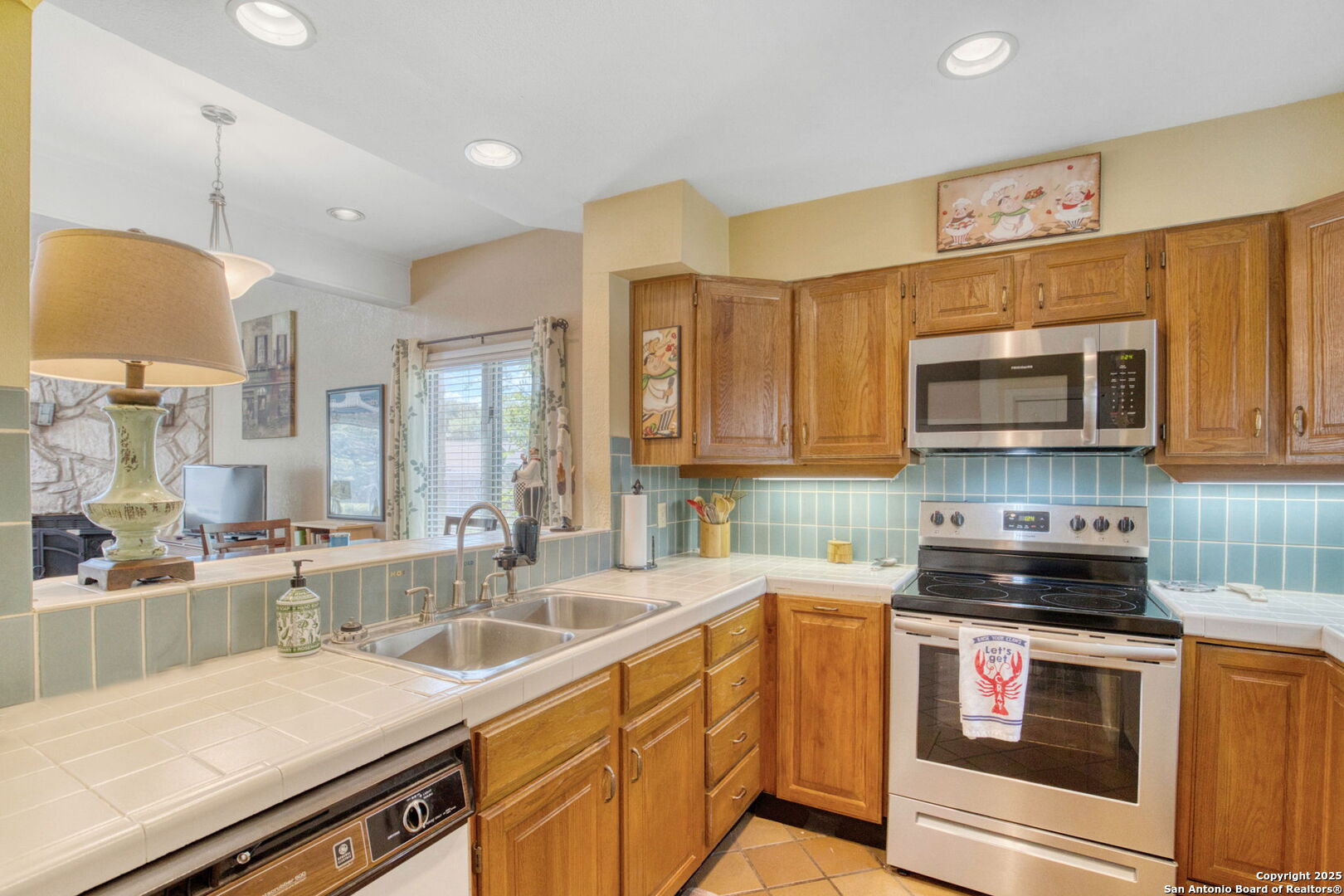 805 Highway 534 Loop, Unit 122 Kerrville, TX 78028 - Photo 12 of 30 a kitchen with stainless steel appliances a stove sink microwave and cabinets