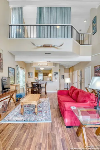 a living room with furniture a rug and a flat screen tv