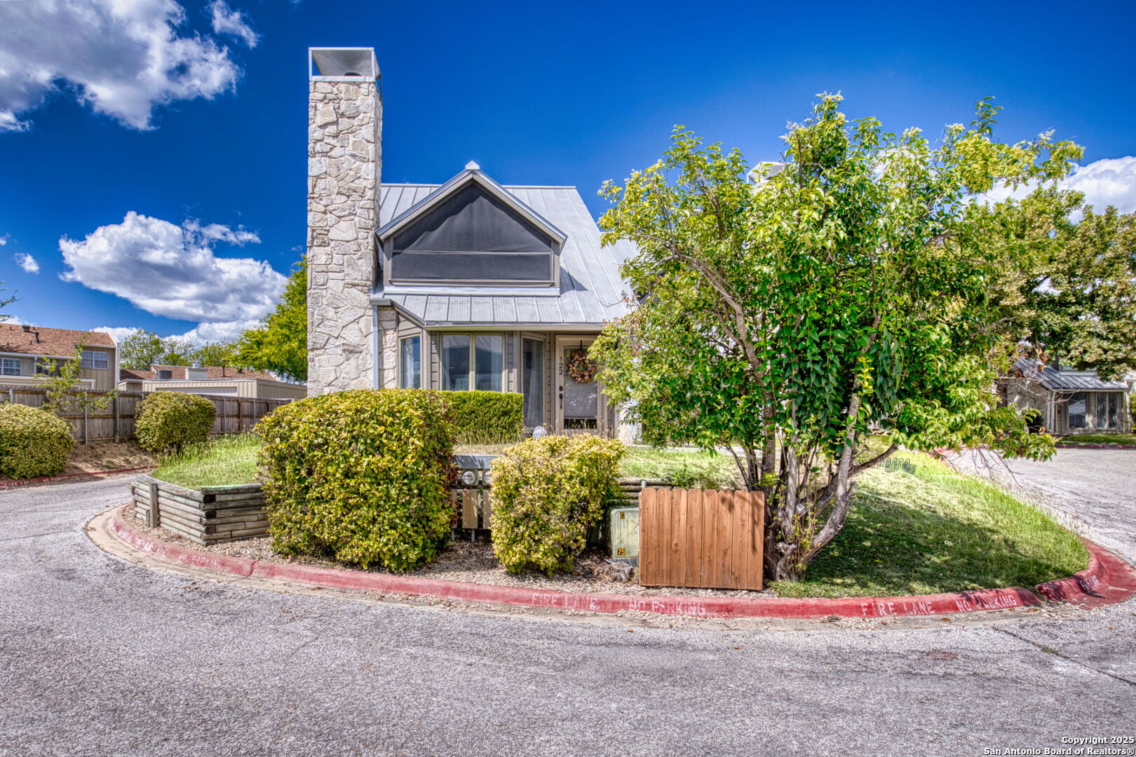 805 Highway 534 Loop, Unit 122 Kerrville, TX 78028 - Photo 2 of 30 a front view of a house with a yard and garage
