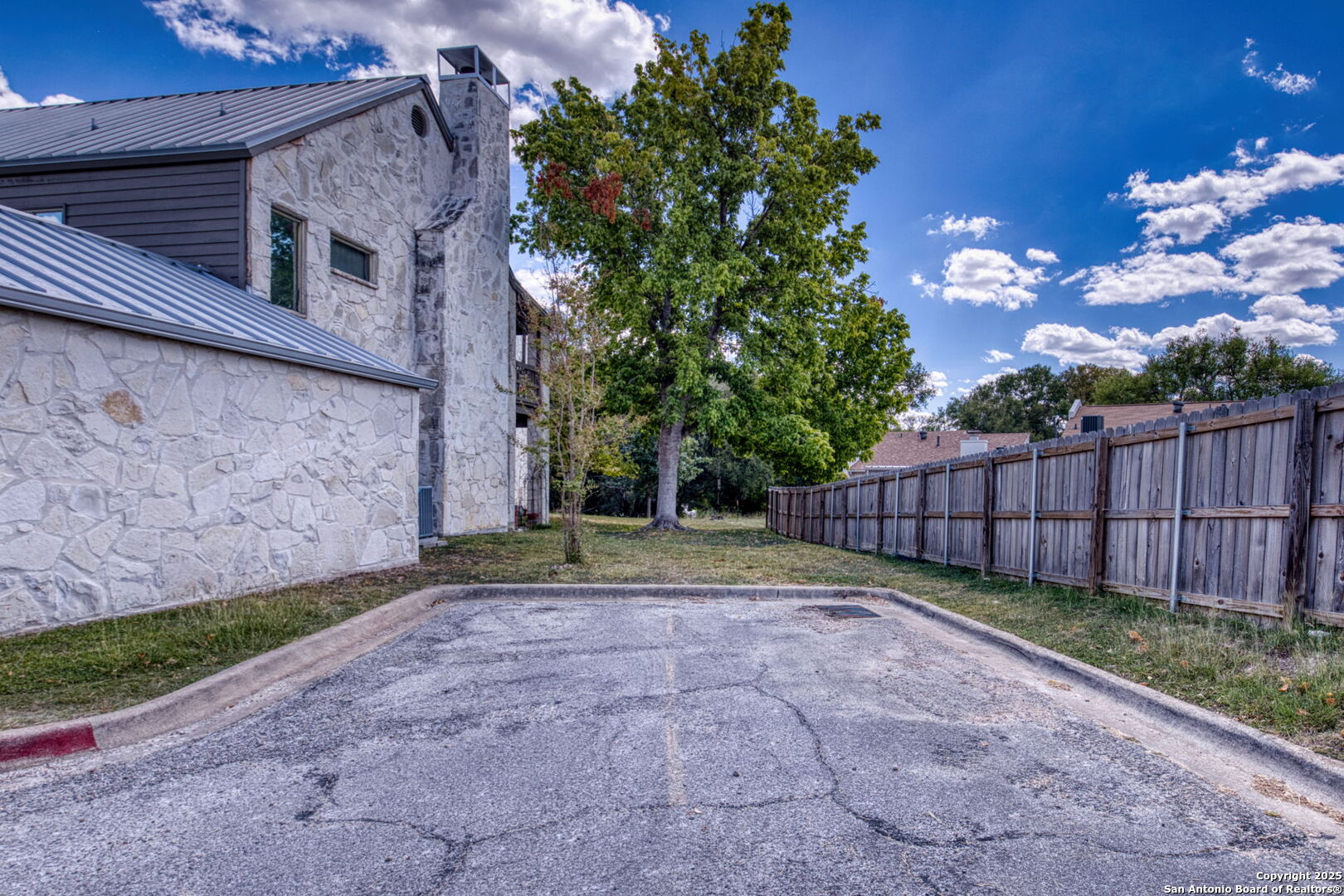 805 Highway 534 Loop, Unit 122 Kerrville, TX 78028 - Photo 22 of 30 a view of backyard with potted plants and wooden fence