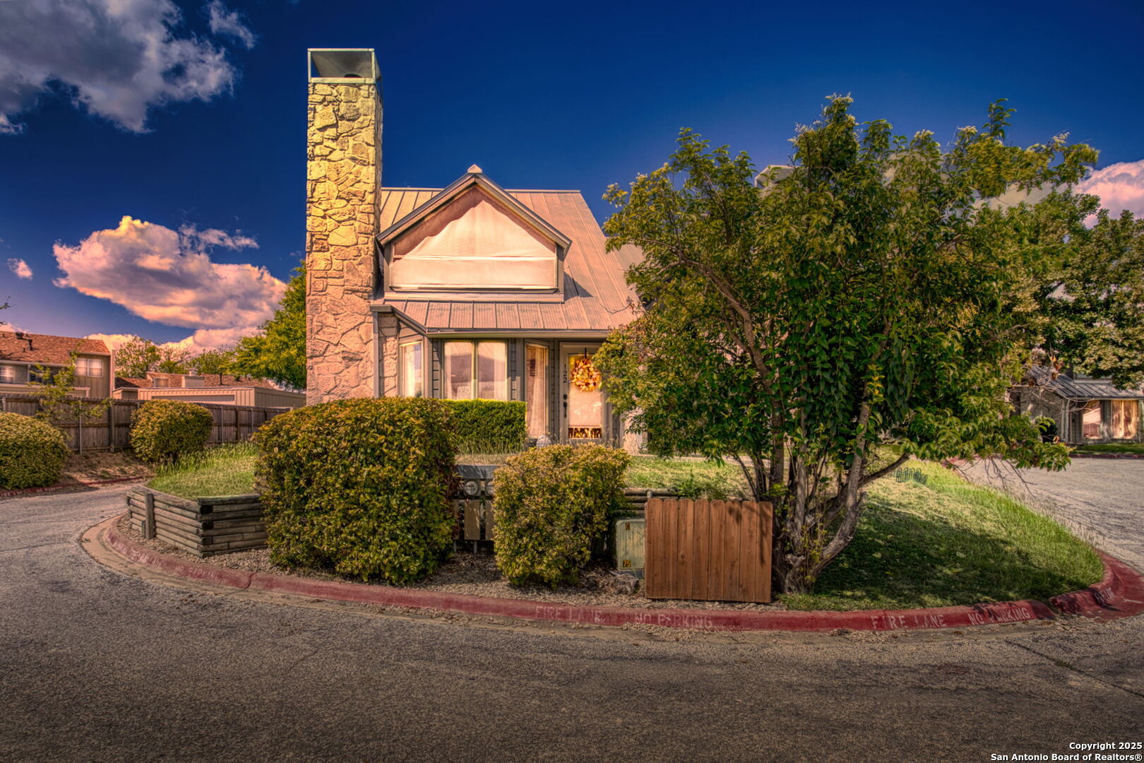 805 Highway 534 Loop, Unit 122 Kerrville, TX 78028 - Photo 3 of 30 a front view of a house with a yard and garage