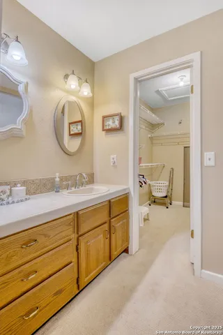 a spacious bathroom with a granite countertop sink mirror and toilet