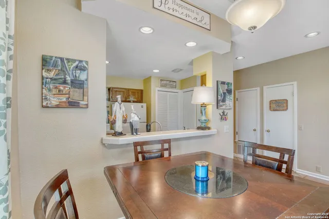 a living room with kitchen island furniture and a table