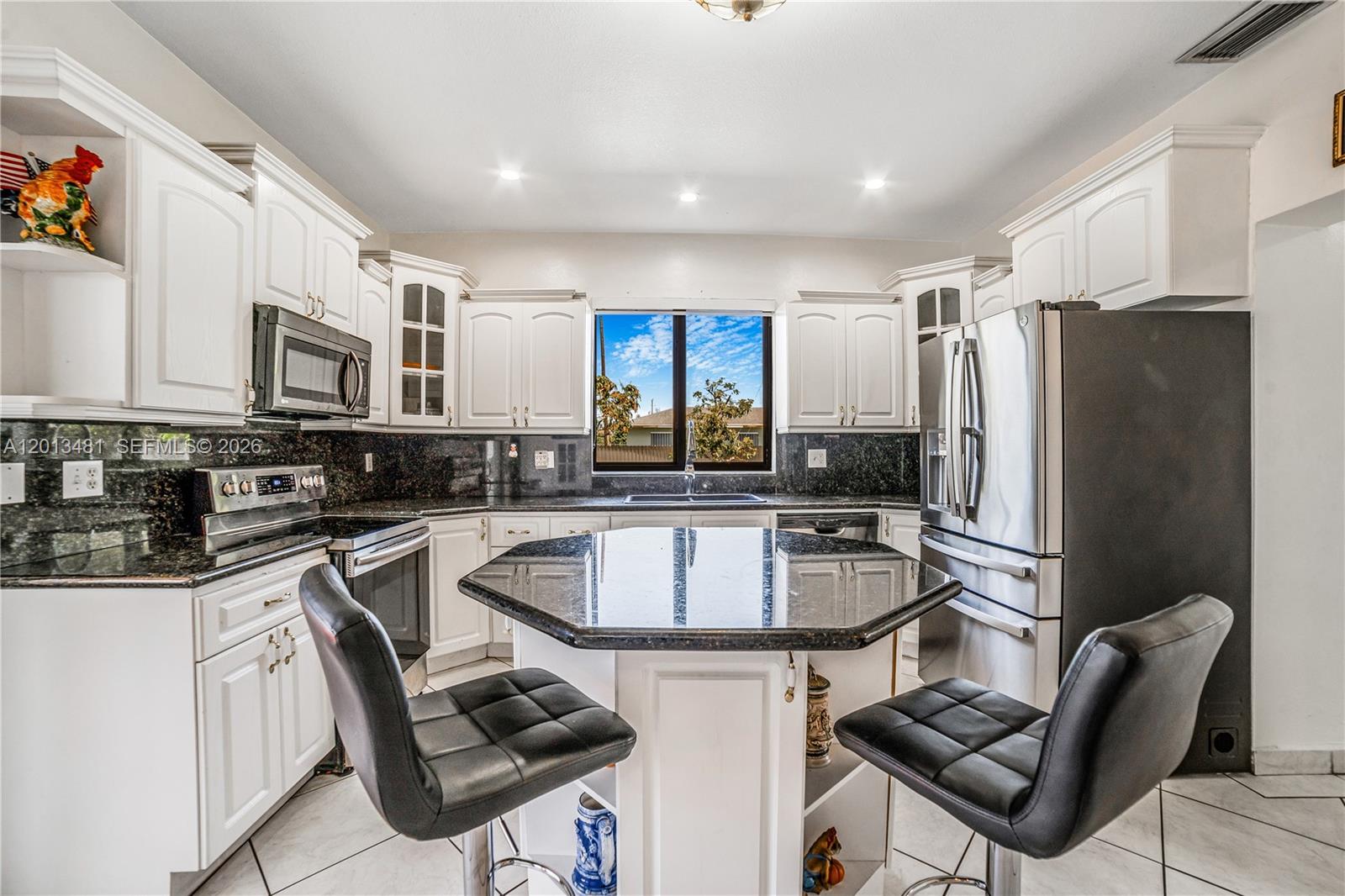 26500 Southwest 167th Avenue Homestead, FL 33031 - Photo 15 of 78 a kitchen with stainless steel appliances granite countertop a stove refrigerator sink and cabinets