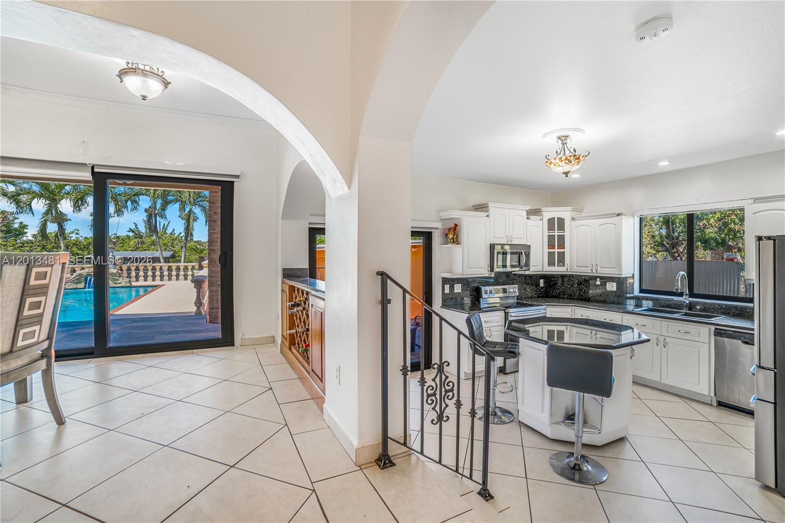 26500 Southwest 167th Avenue Homestead, FL 33031 - Photo 16 of 78 a kitchen with stainless steel appliances a stove a sink and cabinets