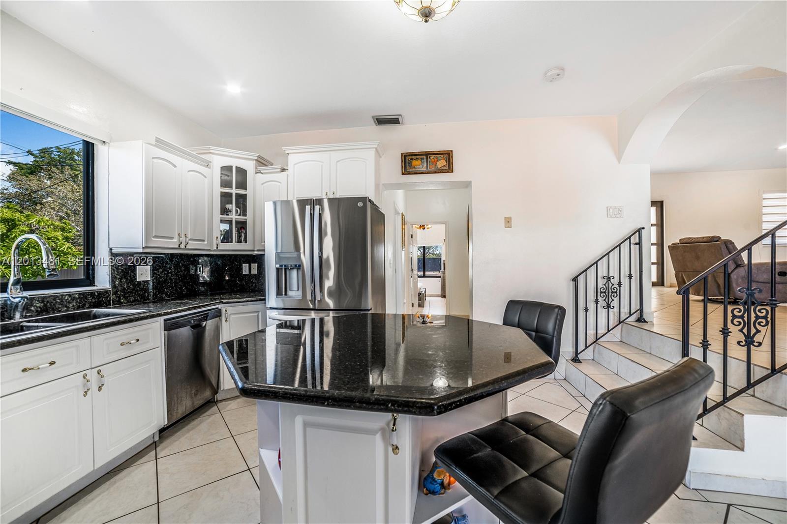 26500 Southwest 167th Avenue Homestead, FL 33031 - Photo 18 of 78 a kitchen with stainless steel appliances granite countertop a sink dishwasher a refrigerator and white cabinets with wooden floor