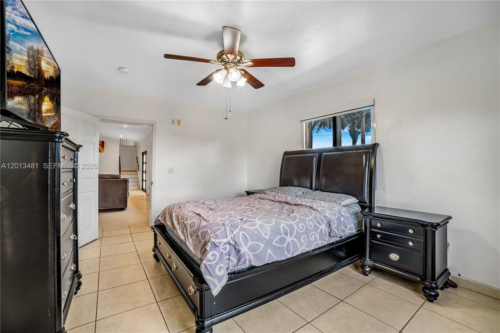 26500 Southwest 167th Avenue Homestead, FL 33031 - Photo 21 of 78 a bedroom with a bed and a flat tv screen on the dresser