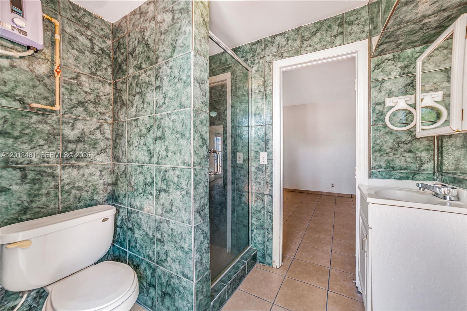 26500 Southwest 167th Avenue Homestead, FL 33031 - Photo 22 of 78 a bathroom with a toilet and a shower