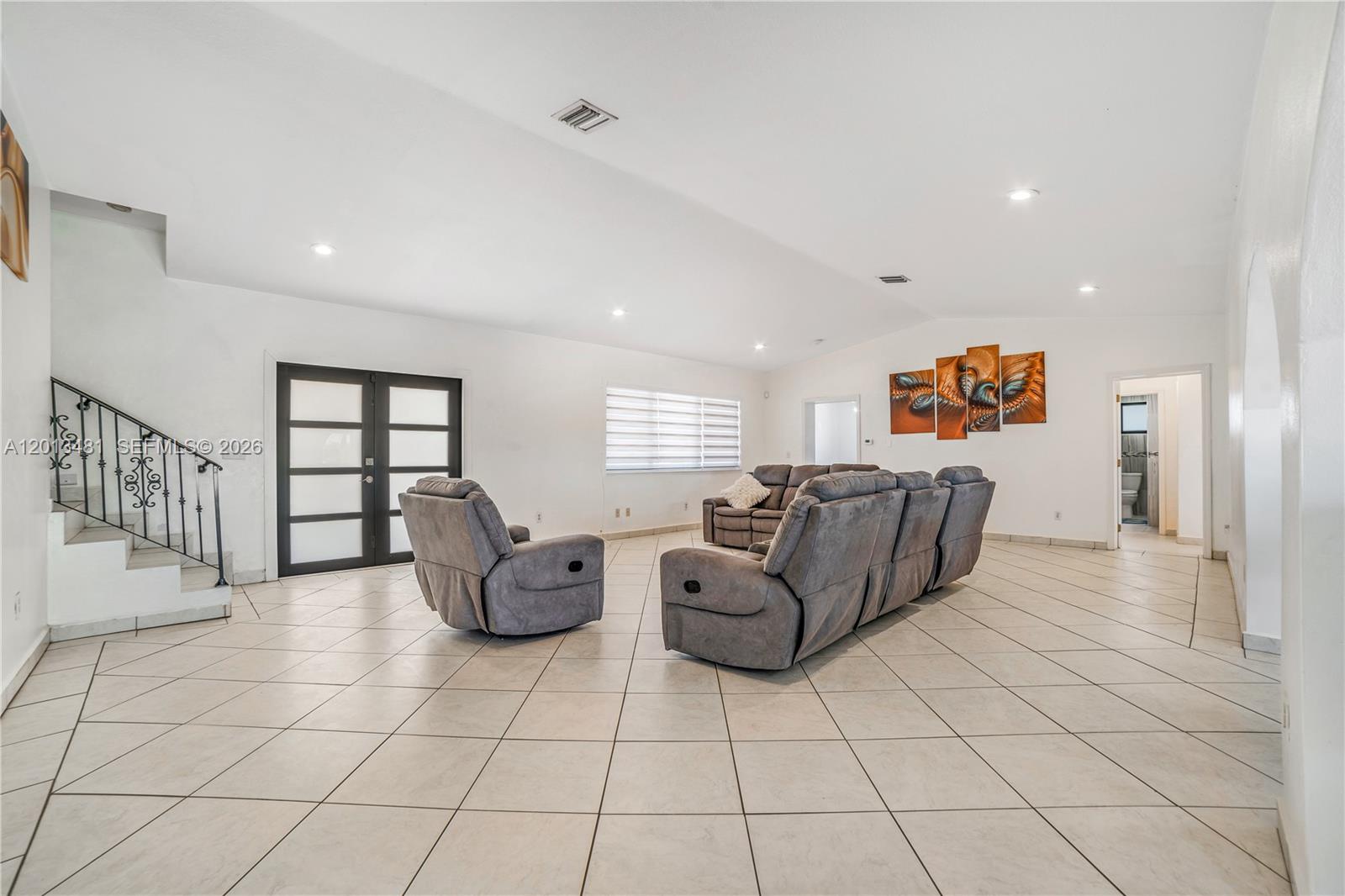 26500 Southwest 167th Avenue Homestead, FL 33031 - Photo 41 of 78 a living room with furniture gym equipment and a rug