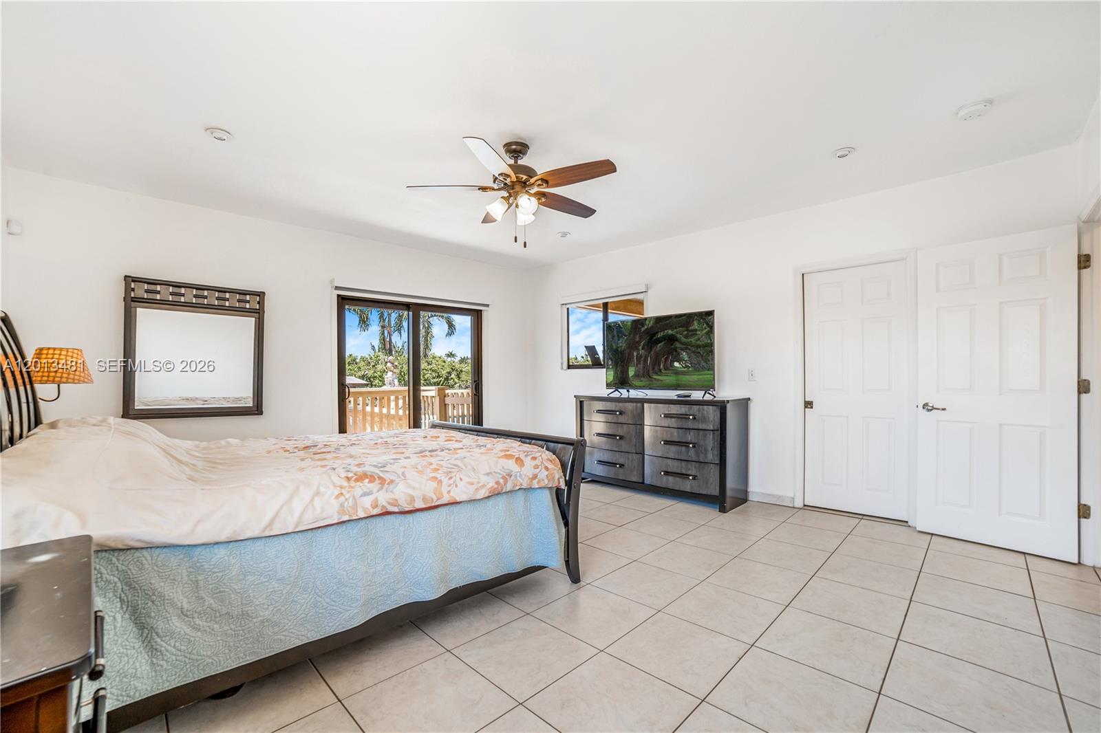 26500 Southwest 167th Avenue Homestead, FL 33031 - Photo 42 of 78 a spacious bedroom with a bed and a dresser in it