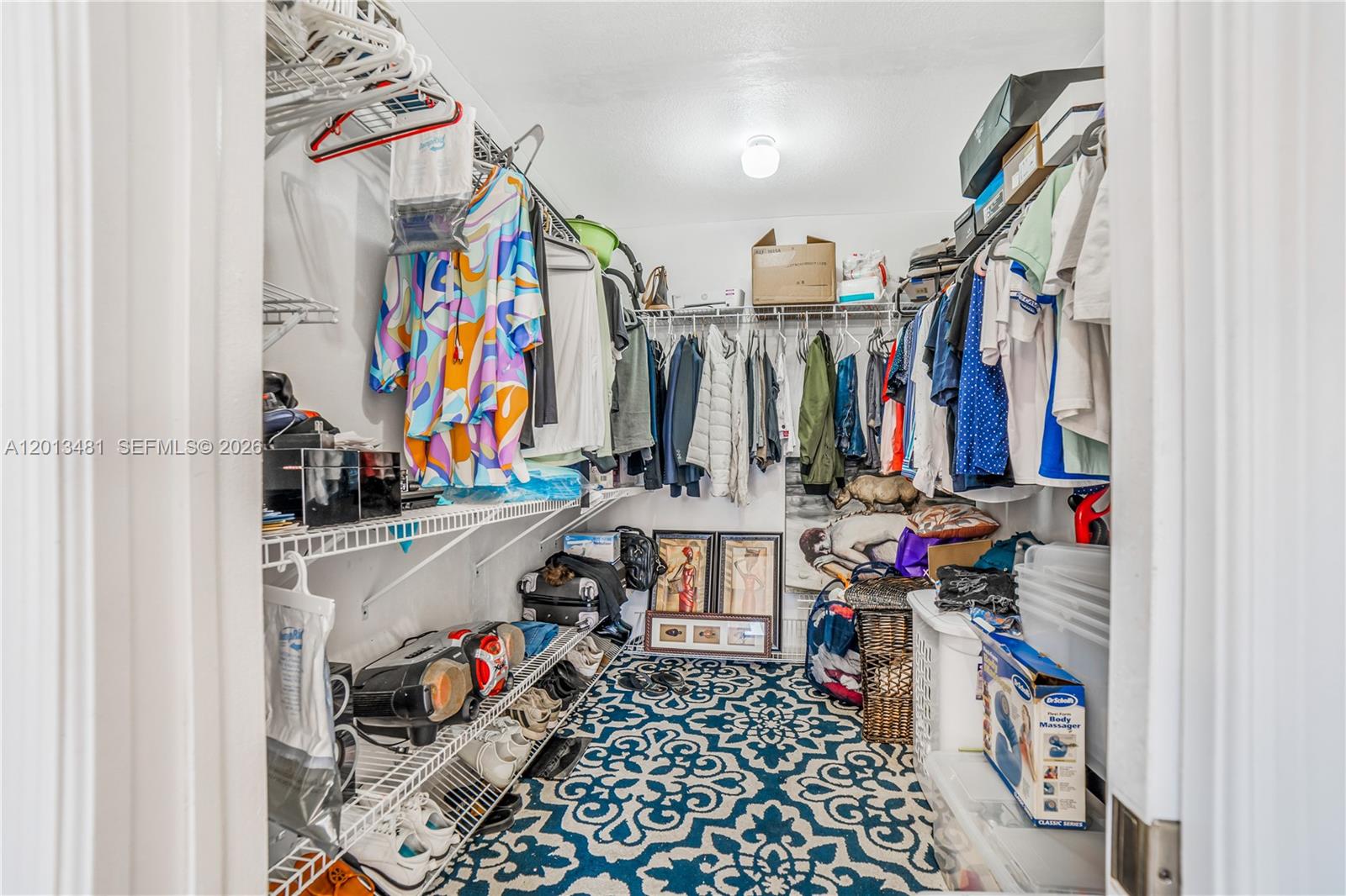 26500 Southwest 167th Avenue Homestead, FL 33031 - Photo 43 of 78 a view of walk in closet with clothes and shoes