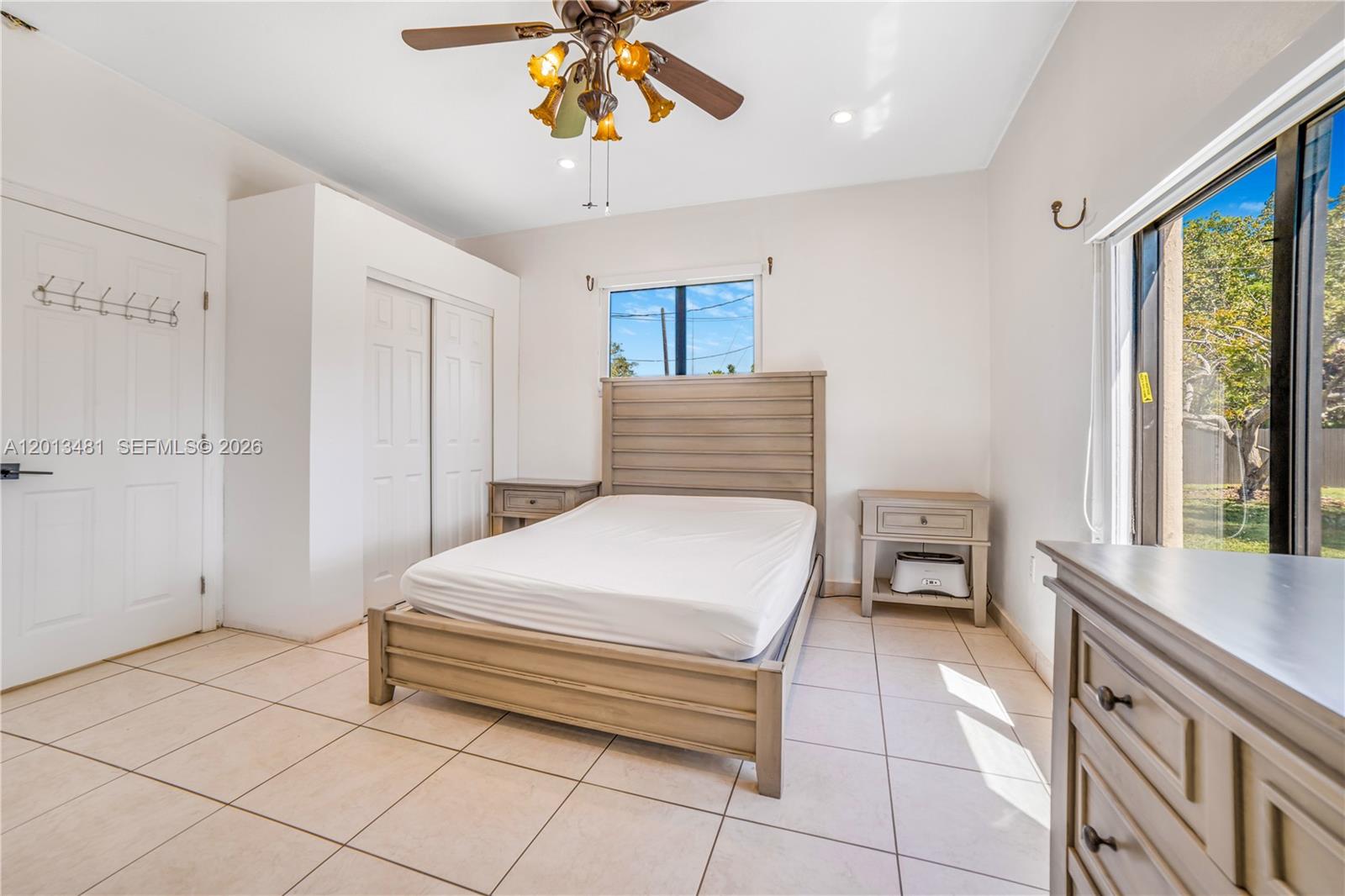 26500 Southwest 167th Avenue Homestead, FL 33031 - Photo 50 of 78 a bedroom with a bed and a chandelier