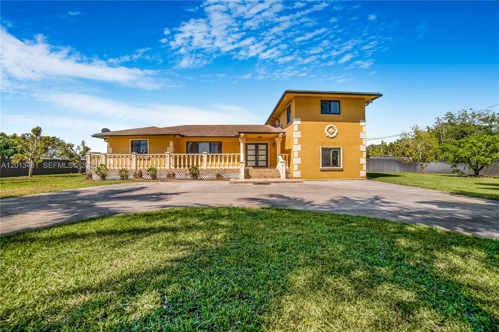 26500 Southwest 167th Avenue Homestead, FL 33031 - Photo 5 of 78 a front view of a house with a yard