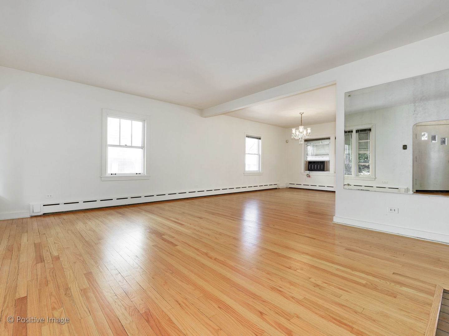 399 Longcommon Road Riverside, IL 60546 - Photo 2 of 25 an empty room with wooden floor and windows