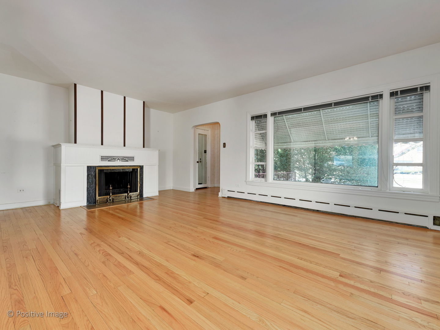 399 Longcommon Road Riverside, IL 60546 - Photo 4 of 25 a view of empty room with wooden floor and fireplace