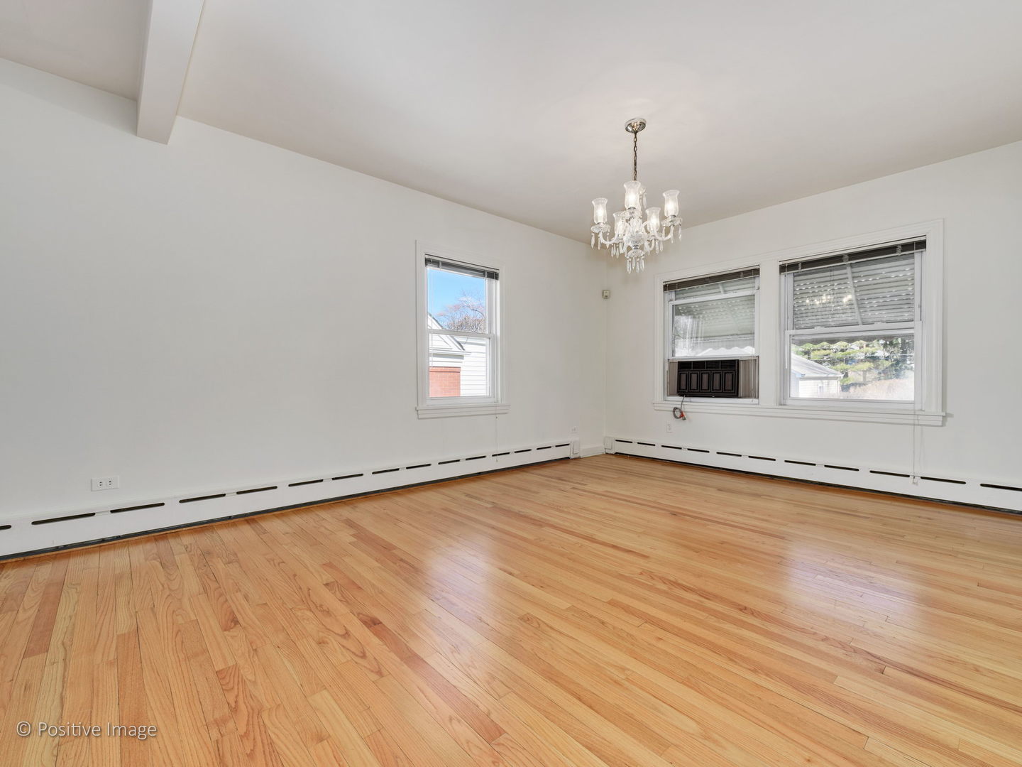 399 Longcommon Road Riverside, IL 60546 - Photo 5 of 25 a view of an empty room with window and wooden floor