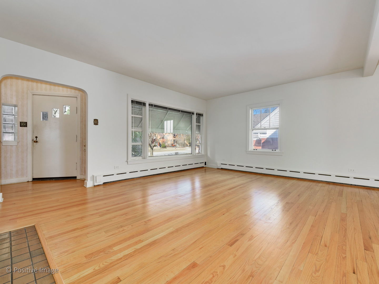 399 Longcommon Road Riverside, IL 60546 - Photo 6 of 25 an empty room with wooden floor and windows