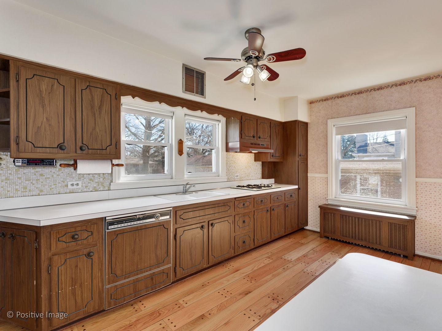 399 Longcommon Road Riverside, IL 60546 - Photo 8 of 25 a large kitchen with kitchen island granite countertop a sink window and cabinets