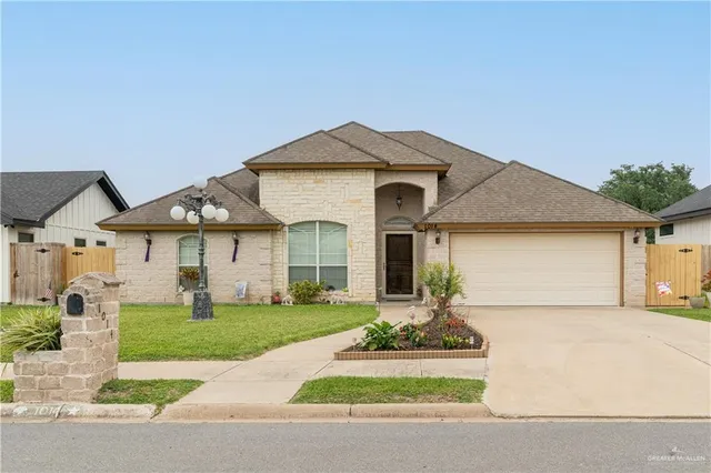 a front view of a house with a yard and garage