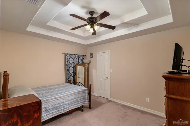 a bedroom with a bed and a ceiling fan