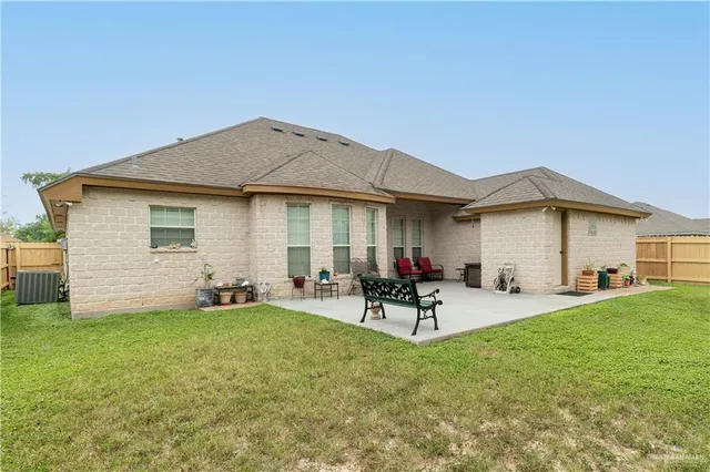 a view of a backyard with table and chairs under an umbrella