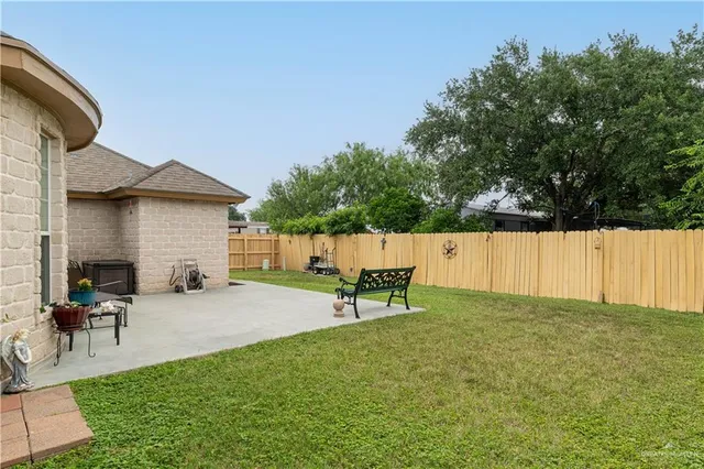 a backyard of a house with table and chairs