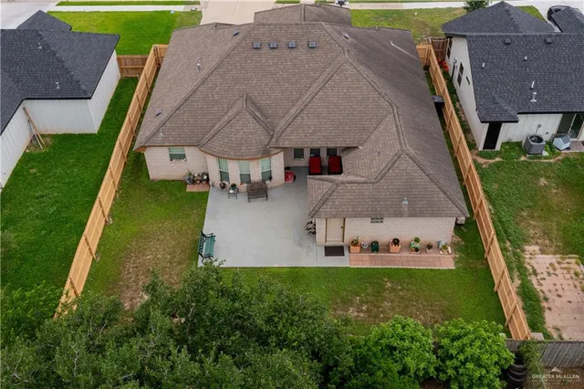 an aerial view of a house with a garden and a yard