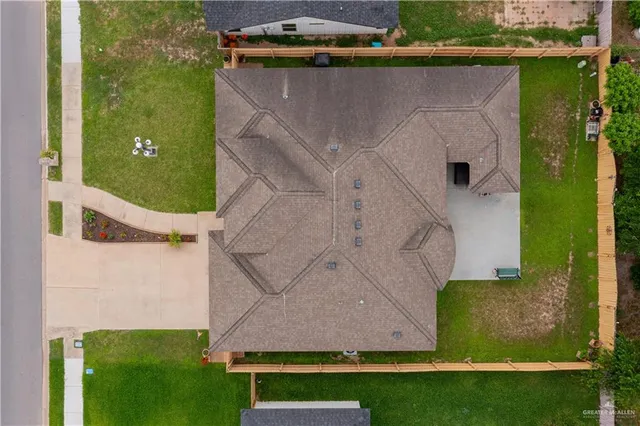 an aerial view of a house with a yard