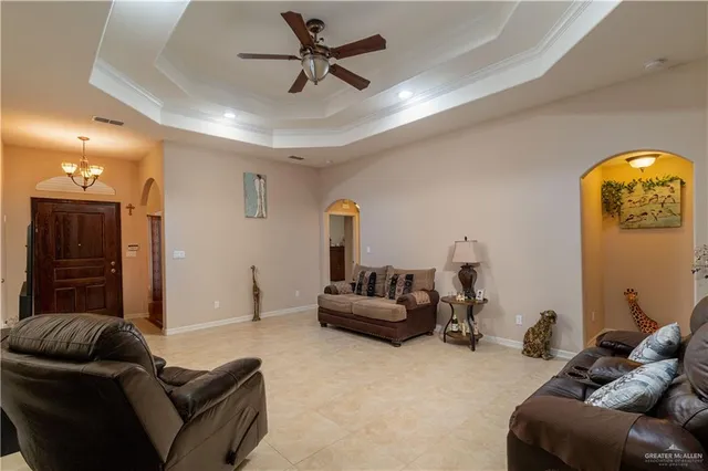 a living room with furniture and a mirror