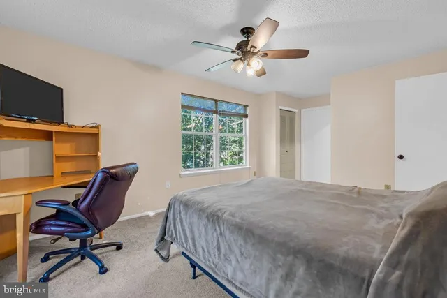 a bedroom with a workspace