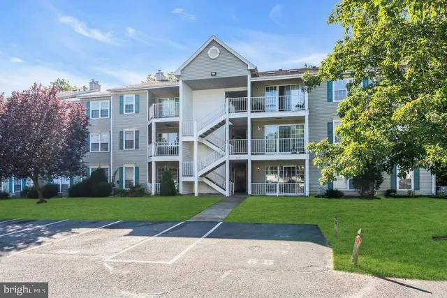 a view of a brick house with a yard