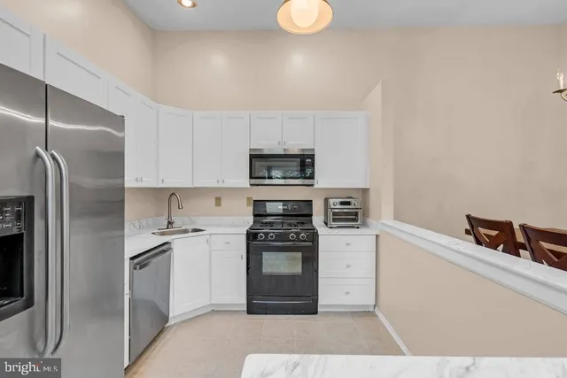 a kitchen with a refrigerator stove and microwave