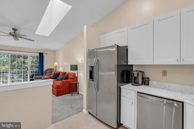 a kitchen with stainless steel appliances granite countertop a refrigerator sink and cabinets