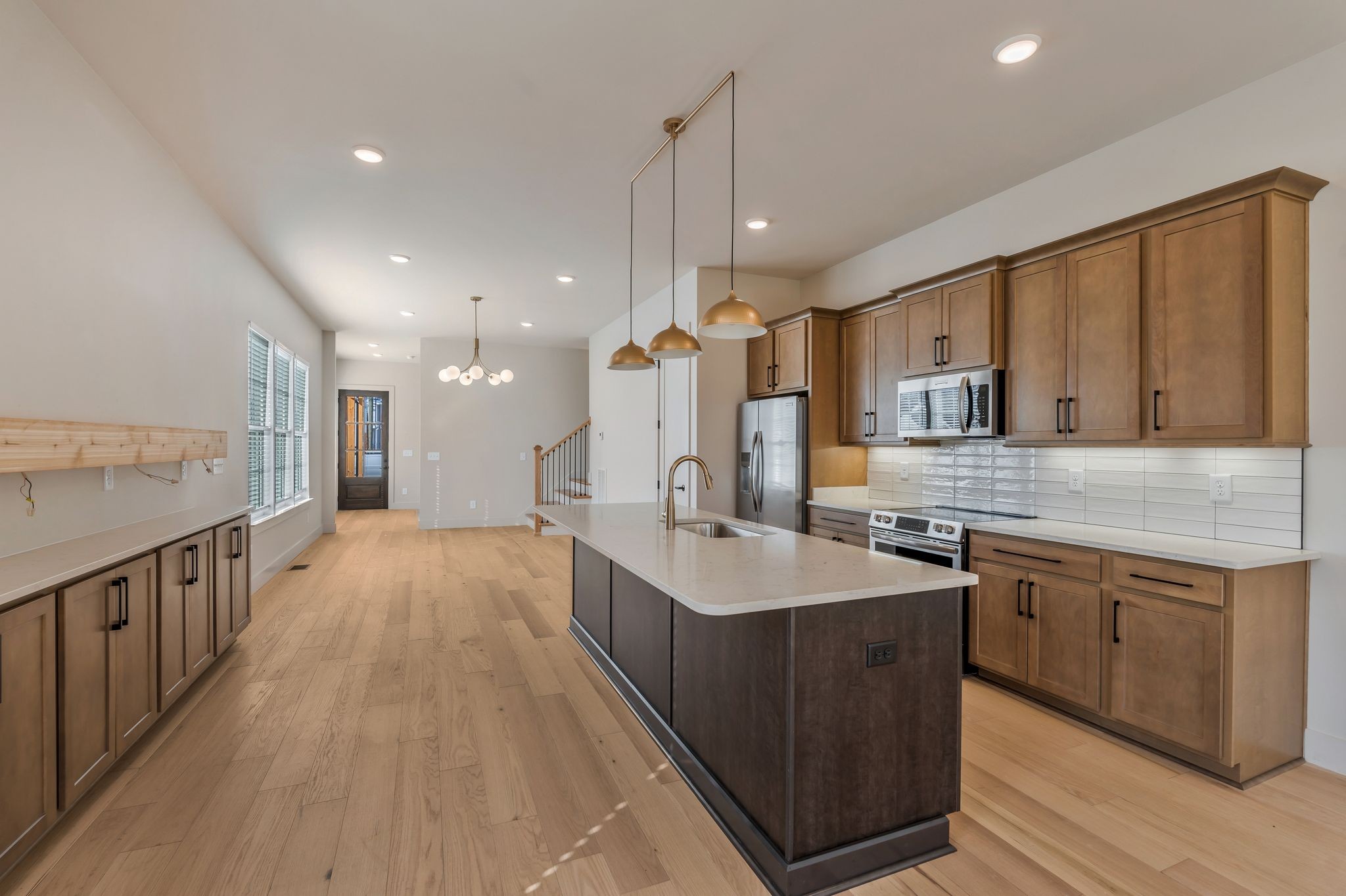 915 B Marilyn Road Nashville, TN 37209 - Photo 16 of 44 a large kitchen with kitchen island a sink a center island a stove and a wooden floors