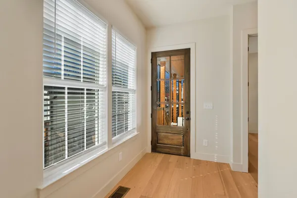 a view of wooden floor and windows in a room