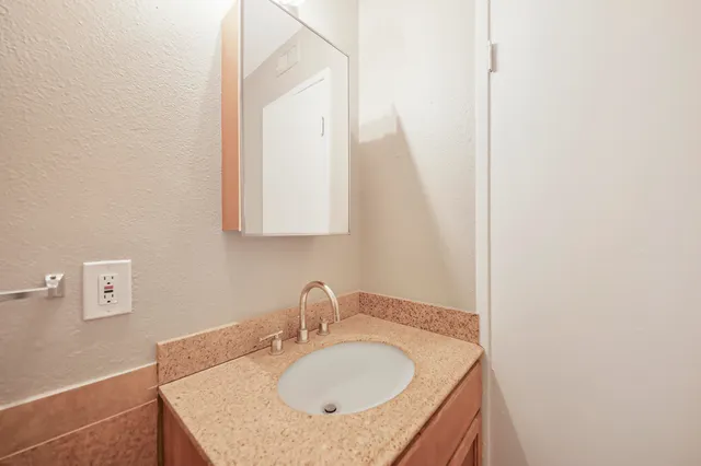 a bathroom with a sink and a mirror