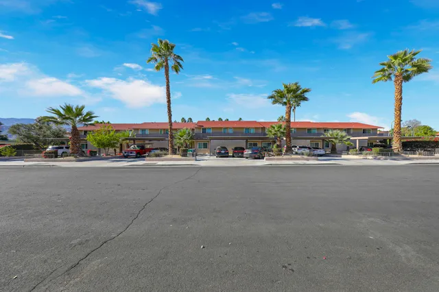 a street sign on a sidewalk next to a road