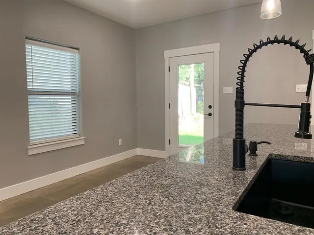 a view of a kitchen with a sink and a window