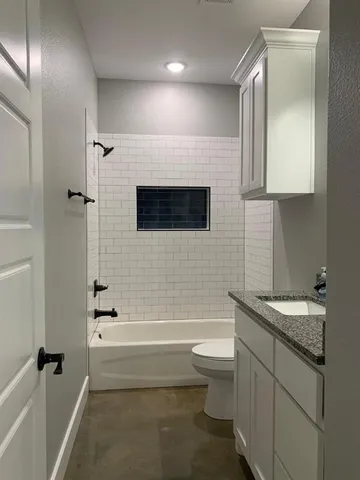 a bathroom with a sink a toilet and bathtub