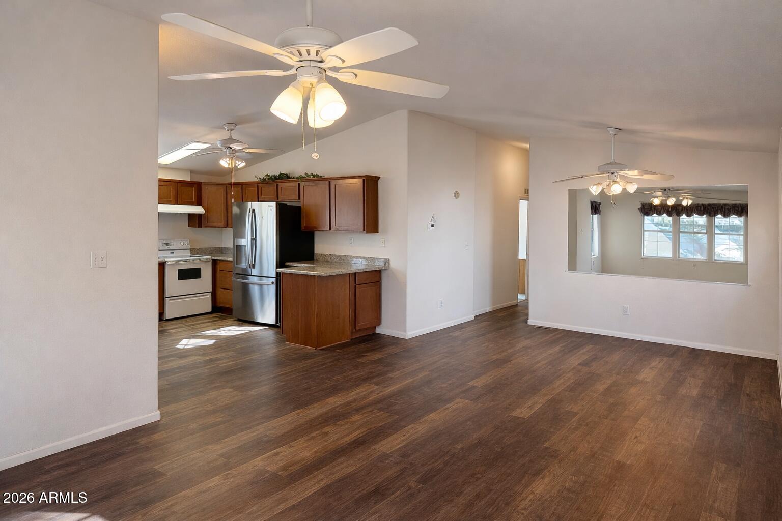 3700 South Tomahawk Road, Unit 13 Apache Junction, AZ 85119 - Photo 12 of 19 a view of a kitchen with a sink a kitchen microwave and cabinets