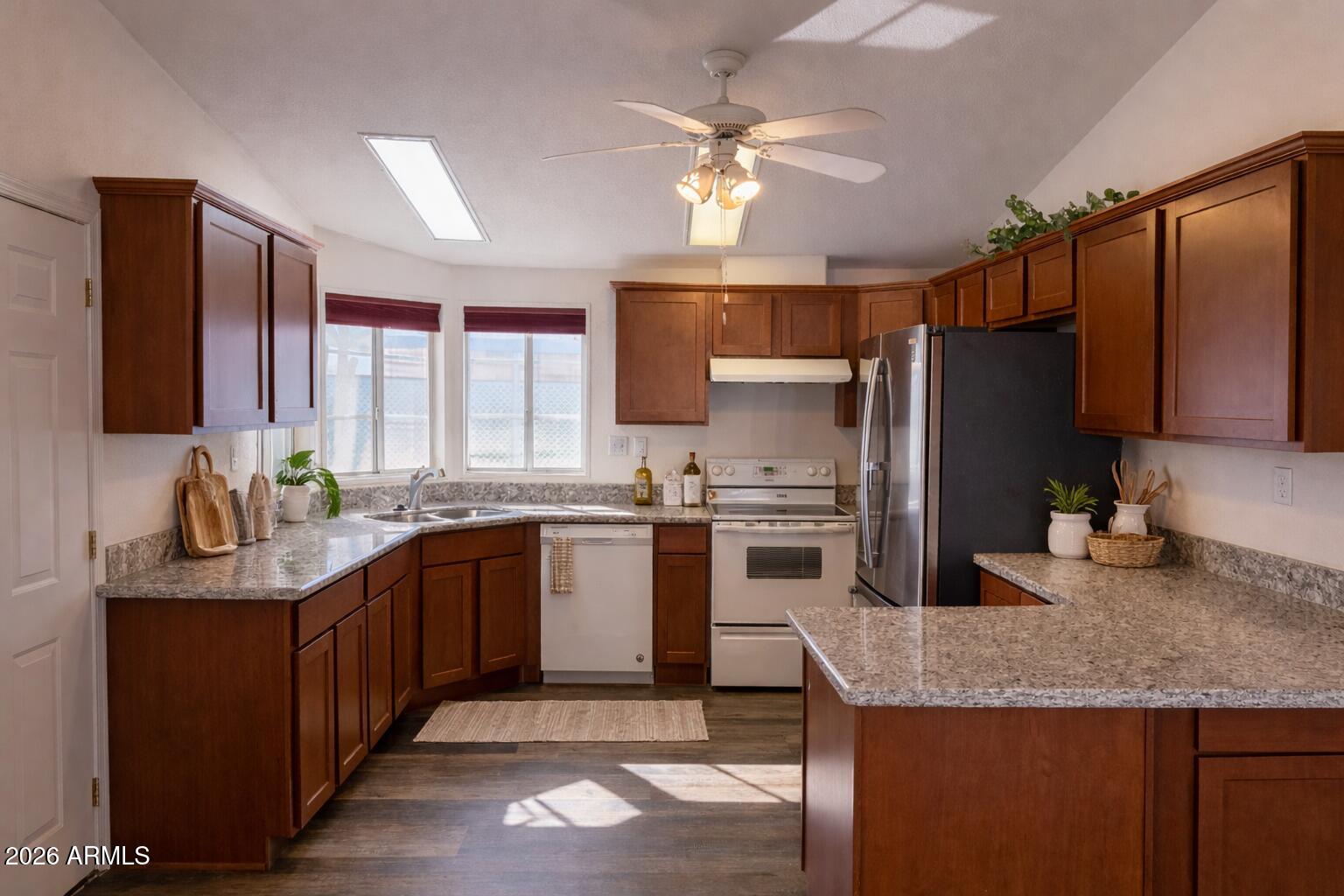 3700 South Tomahawk Road, Unit 13 Apache Junction, AZ 85119 - Photo 3 of 19 a kitchen with stainless steel appliances granite countertop a sink stove and refrigerator