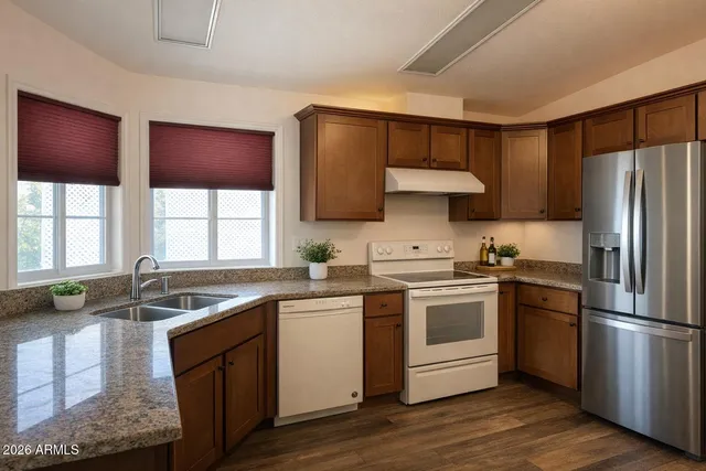 a kitchen with a stove a sink and a refrigerator